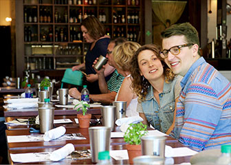a group of people sitting at a table in a restaurant
