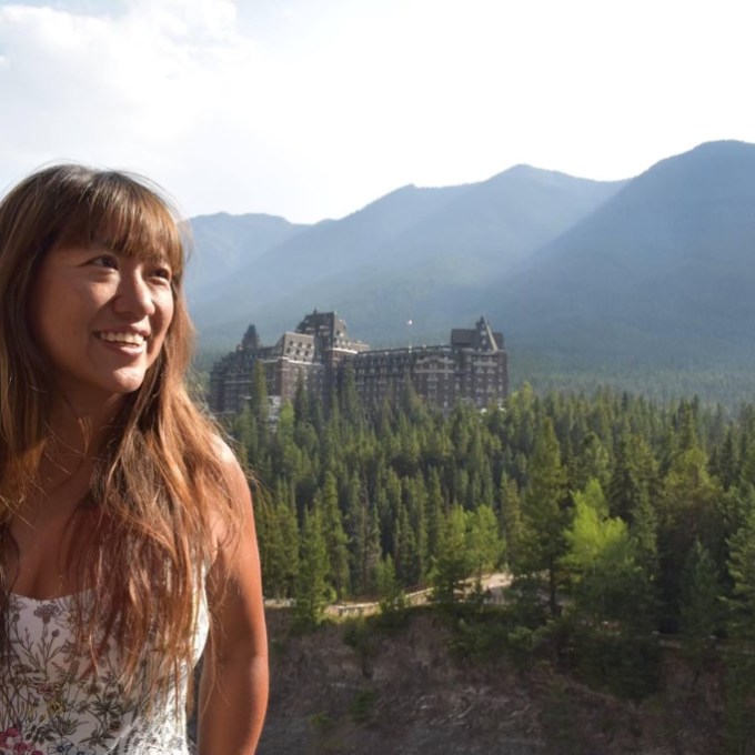 a person standing in front of a mountain