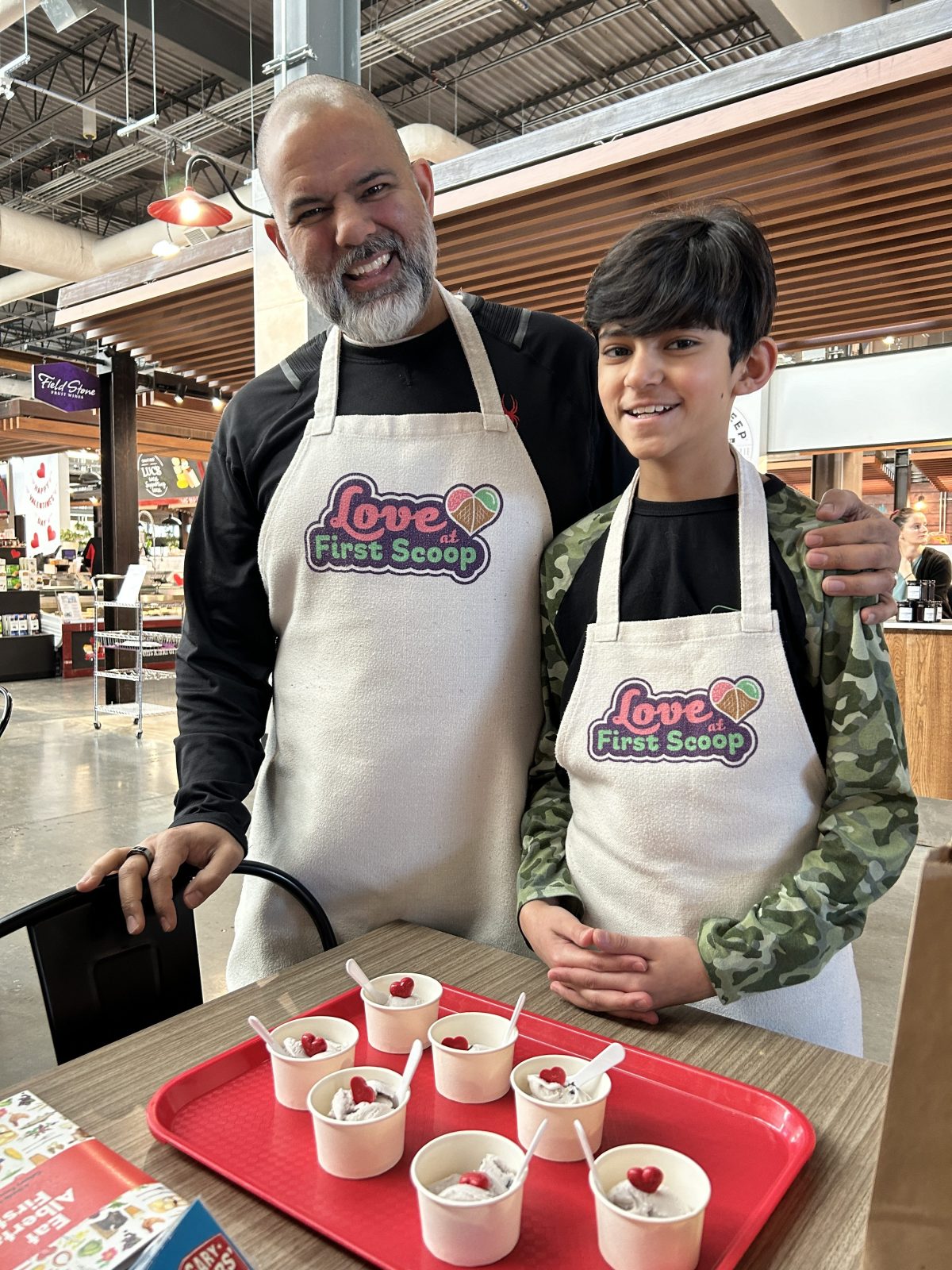 a father and son with aprons on