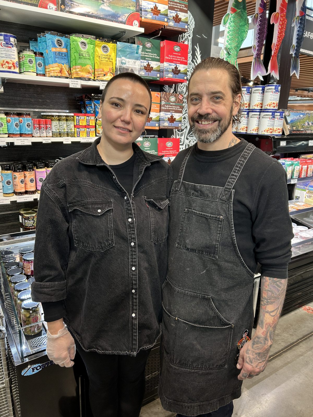 a man and a woman standing in front of a store