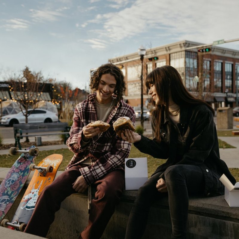 a man and a woman sitting on a bench