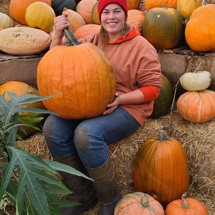 a woman sitting on a pile of fruit