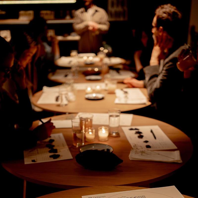 a group of people sitting at a table with wine glasses