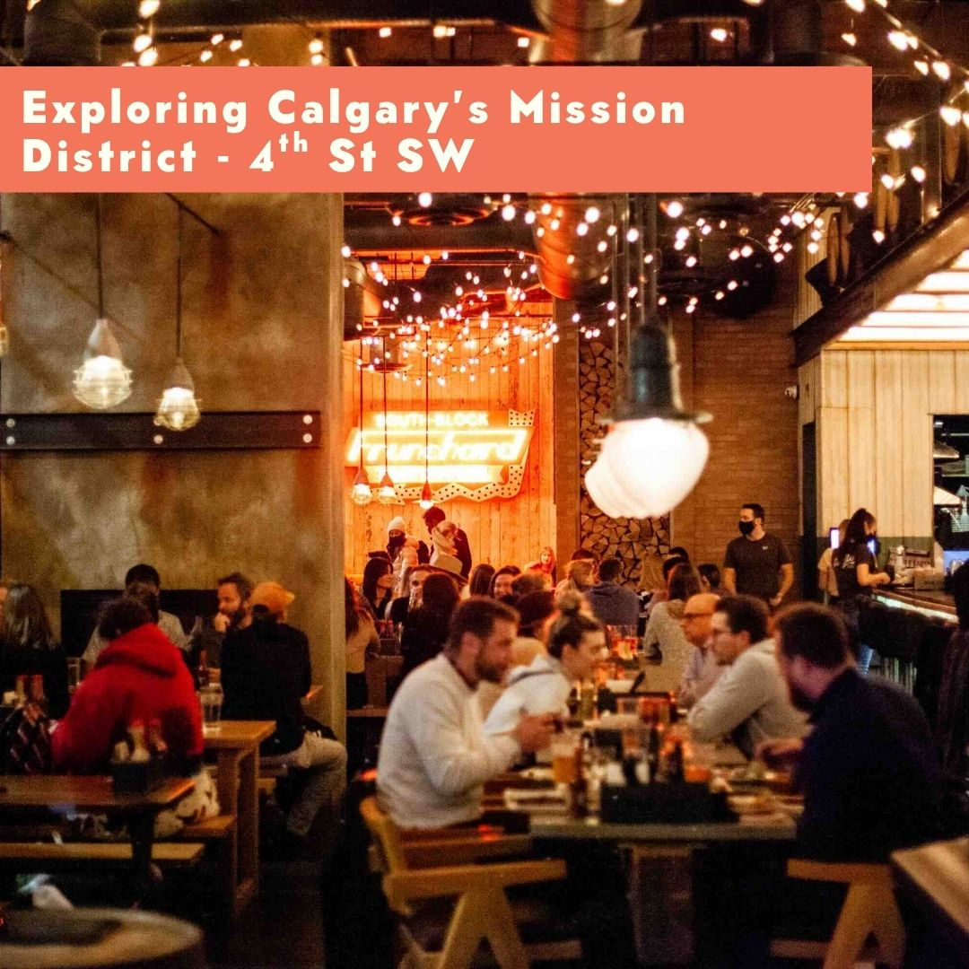 Crowded restaurant with string lights and a neon sign, people dining and socializing.